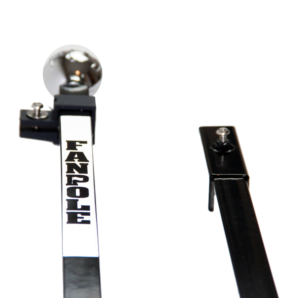Close-up of the FanPole upper pole with chrome ball finial, flag clamp with thumb screw and FANPOLE label, next to the top of the lower pole section