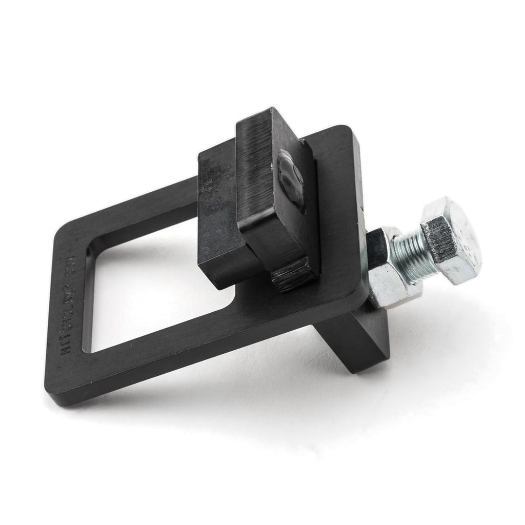 Black steel clamp-style hitch tightener with square receiver frame, clamp block and zinc-plated bolt and nut