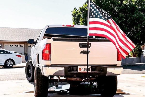 Pickup truck flying a full-size American flag on a FanPole truck hitch flag pole